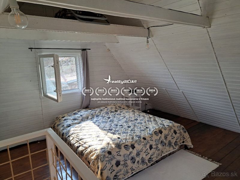 Bedroom with wood-patterned flooring and a bed in a cabin.