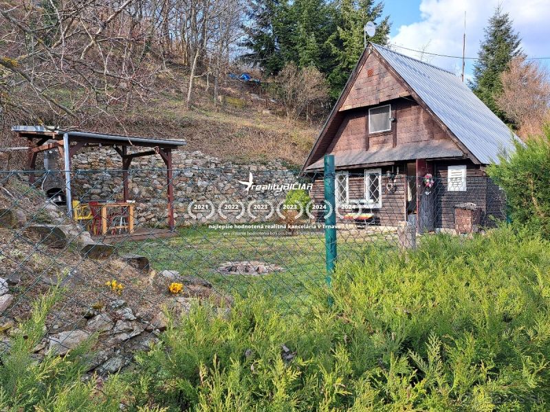 A cottage with wooden decor in the village of Dolné Orešany, on Dolné Orešany street, surrounded by nature.