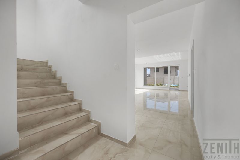 Stairs and a bright hallway in a family house, floor with wooden decor.
