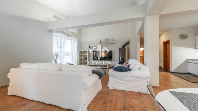 Recreational apartment with white sofas and a wooden decor floor, bright environment.