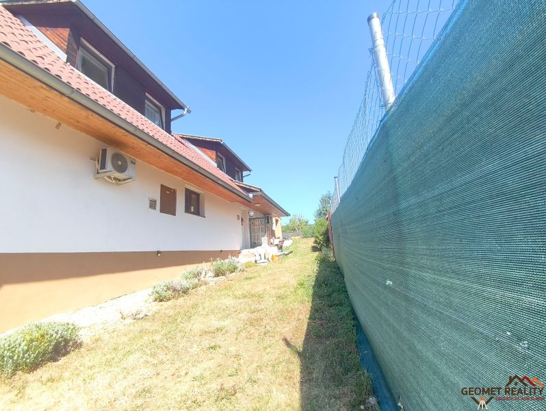A family house in Divín with air conditioning, fencing, and a garden with a lawn.