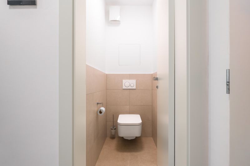A bathroom with tiles in a 2-room apartment, neutral color palette.