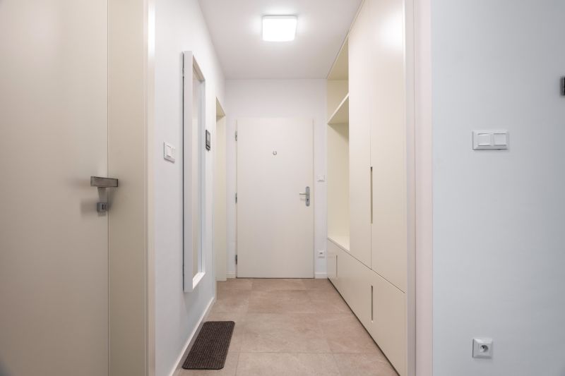 Entrance hallway in a 2-room apartment with tiles and built-in wardrobes.
