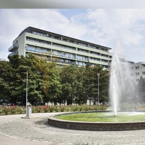 Fountain at Račianske Mýto in Bratislava - Nové Mesto with an apartment building in the background.