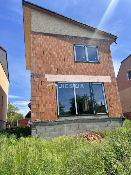 A family house in Cerová in the construction phase with an unplastered brick facade.