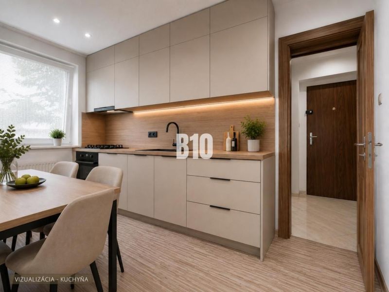A bright kitchen with wood-patterned flooring and a simple table in a three-room apartment.