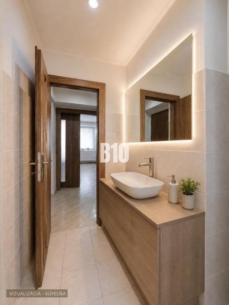 A bathroom in a 3-room apartment with a sink and a backlit mirror on the wall.