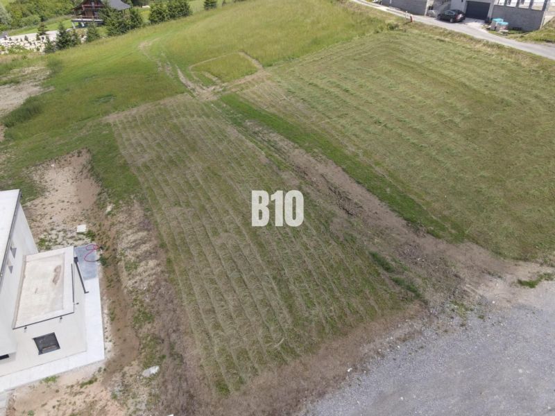 A flat plot in Bitarová ideal for living, surrounded by nature and modern buildings.