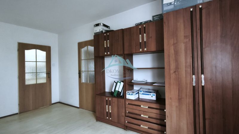Interior of manufacturing spaces with wood-patterned flooring and wooden furniture.