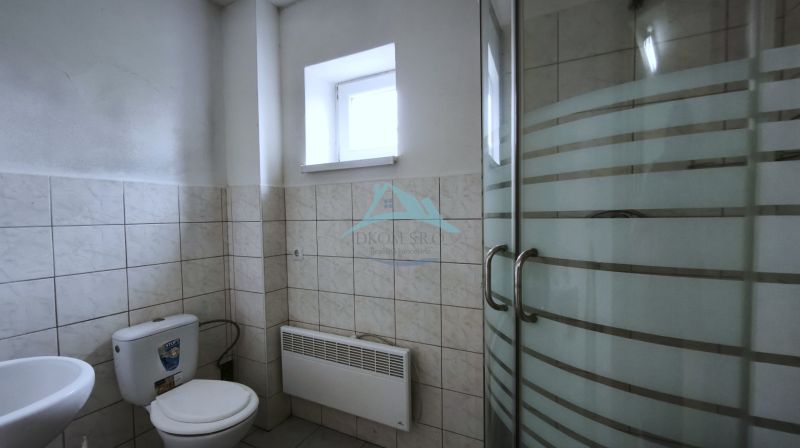 Bathroom with toilet and shower in production facilities.