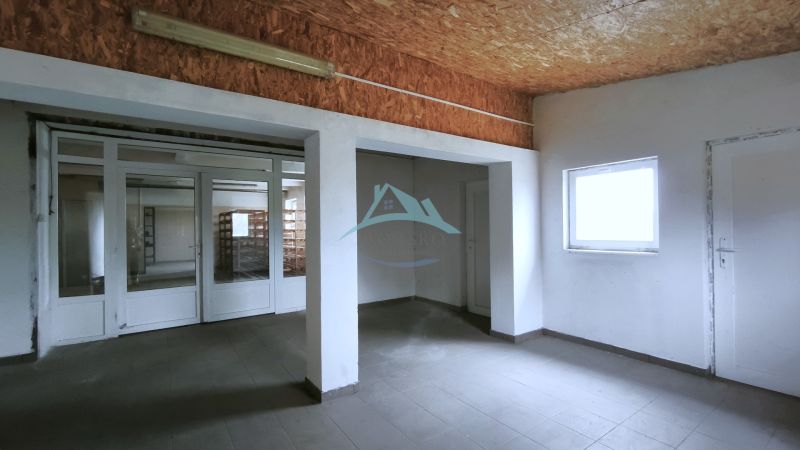 Production premises with white walls and a window, floor with wooden decor.