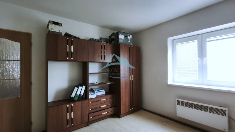 Bright office space with furniture and wood-patterned flooring.