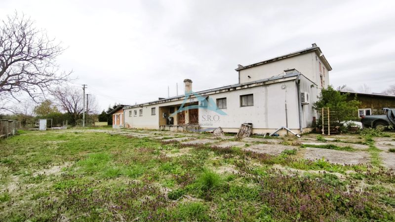 Production premises in Lesenice with an adjacent garden and a simple building facade.