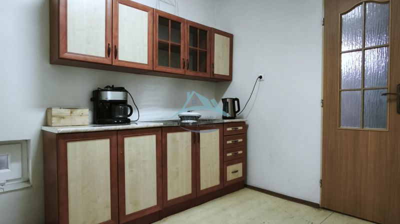 A kitchen in production premises with wooden decor on furniture.