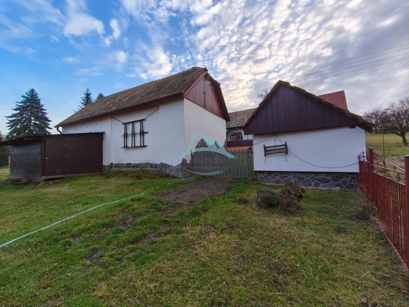 A family house on Prieloh Street in Dolná Strehová with a wooden fence and an extension.