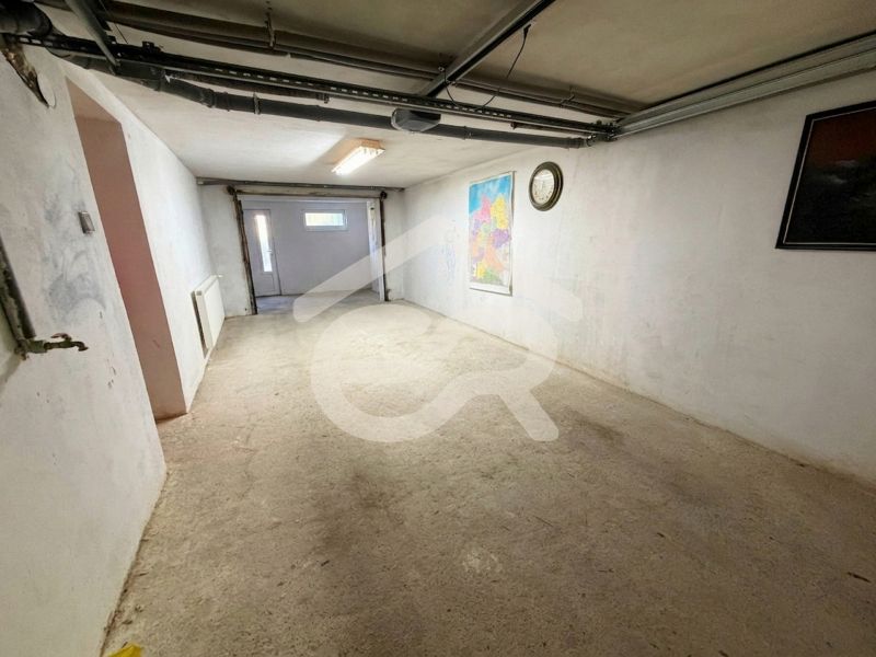 A garage in a family house with a map and a clock on the wall.