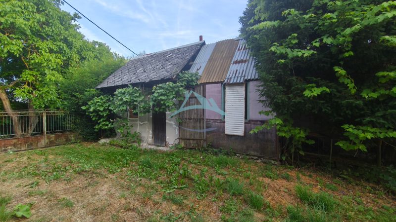 An older family house in Čelovce surrounded by greenery and trees.