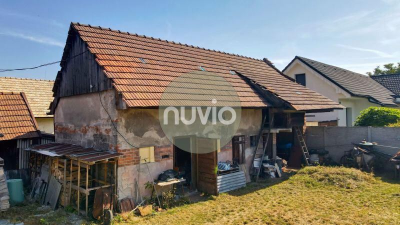 A family house in Žabokreky with an unmaintained garden and an outbuilding on the property.