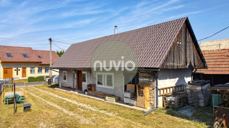 A family house in Žabokreky with a large roof, wooden details, and a yard.