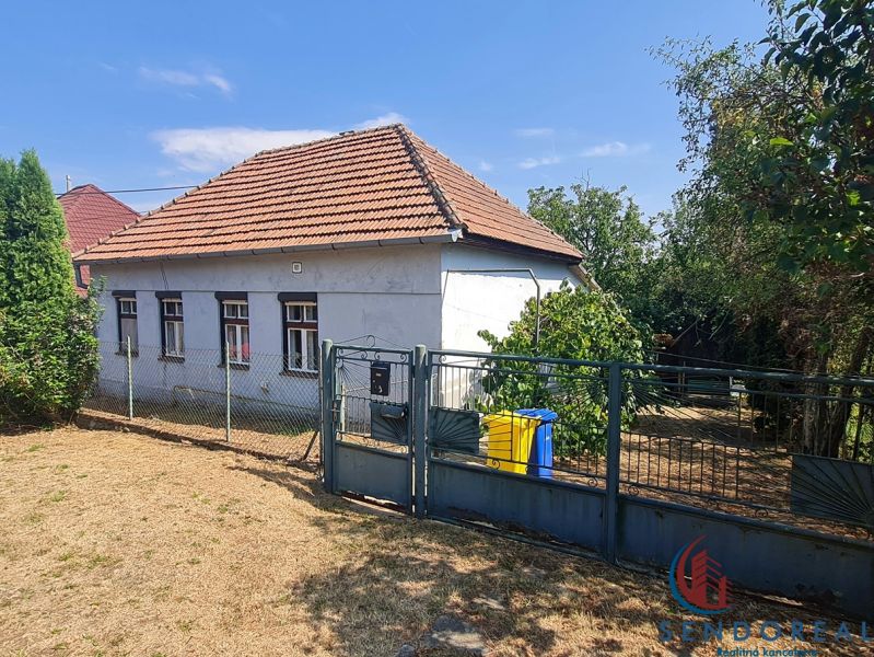 A family house in Dolné Otrokovce with a fence and a garden on a sunny plot.
