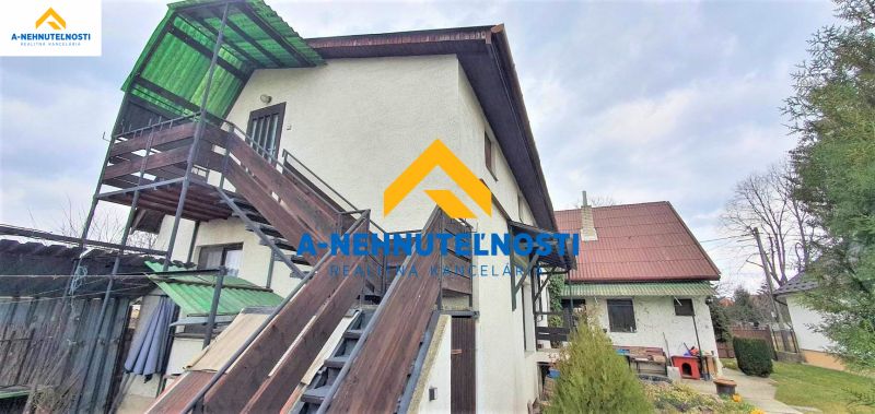 A family house in Veľký Meder with an external staircase and wooden railing.