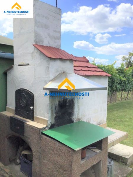 The exterior of a family house in Veľký Meder with a traditional outdoor oven.