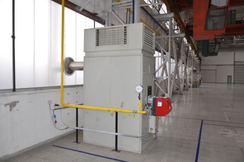 Production facilities with technical equipment and piping on a floor with a wooden decor.