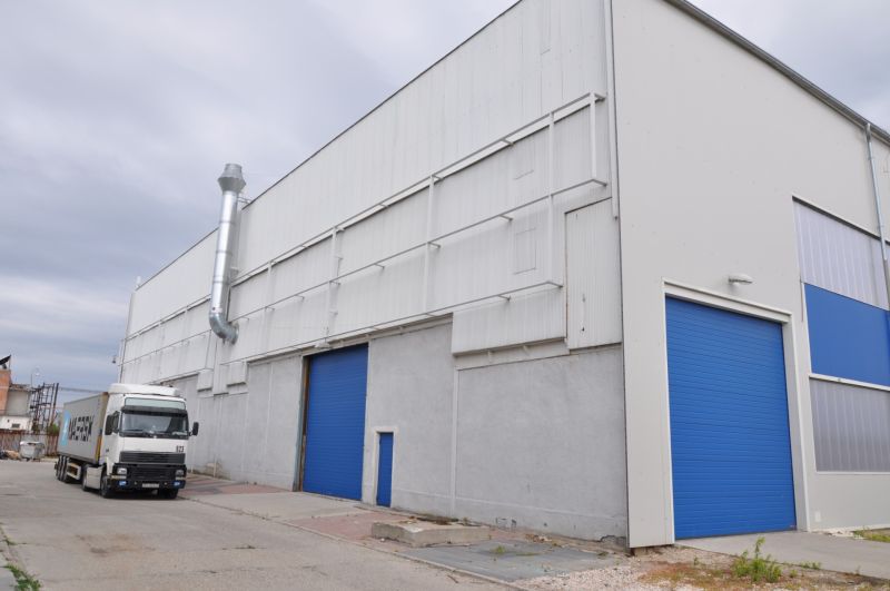 Production facilities on Priemyselná Street in Galanta with a truck in front of the blue gates.