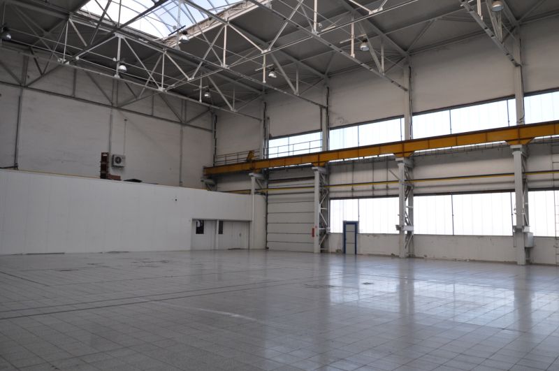 Production facilities with high ceilings, windows, and concrete floors.