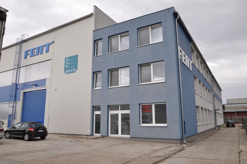 Production premises on Priemyselná Street in Galanta with a gray building and a parking lot.