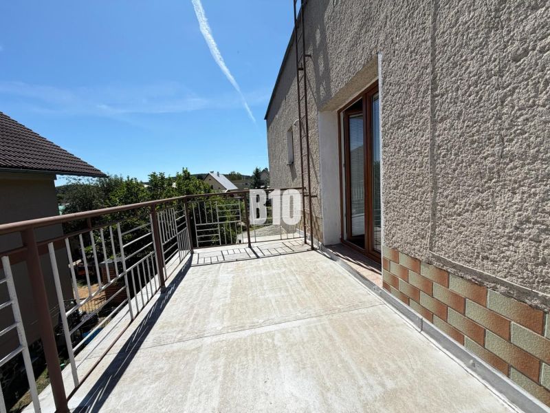 The terrace of a family house in Kláštor pod Znievom with a view of the surrounding greenery.