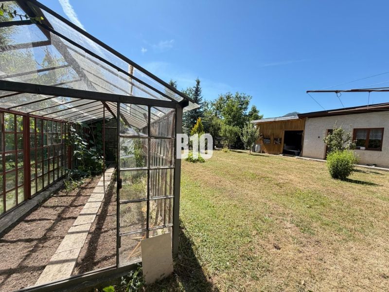A greenhouse and a garden at a family house in Kláštor pod Znievom on a sunny plot.