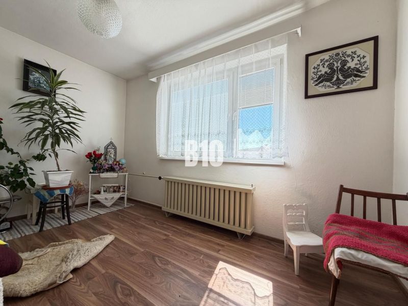Interior of a family house with a wooden decor floor, decorations, and flowers.