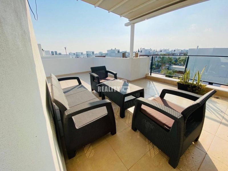 A spacious terrace of a family house with a view in Ynai Boğaziçi, with comfortable rattan seating.