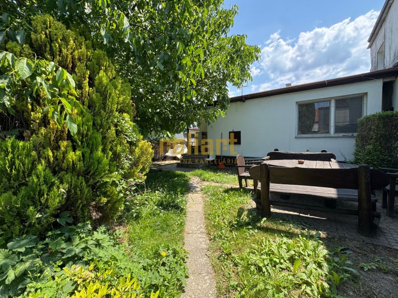 The garden of a family house in Bratislava - Ružinov on Senná Street with wooden seating.