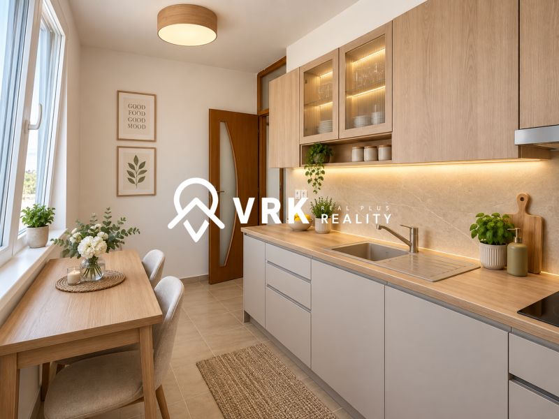 A kitchen in a 2-room apartment with wooden decor and decorative plants on the table.