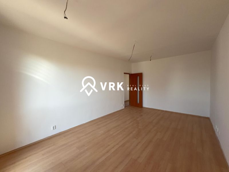 A room with walls in a 2-room apartment and a floor with a wooden decor.