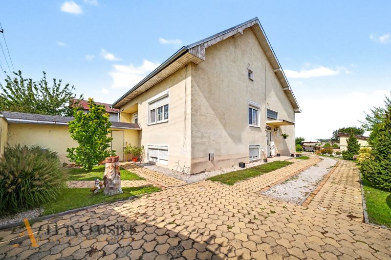 A family house on Vojtechovce Street in Nový Život is surrounded by a well-maintained garden with a walkway.