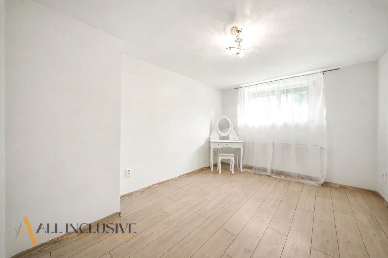 A room with a wooden decor floor and a dressing table in a family house.