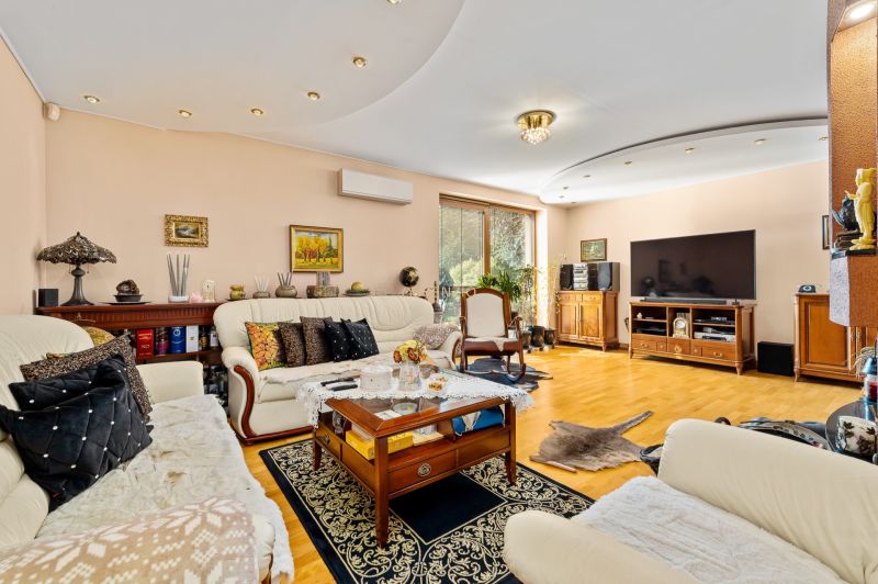 Bright living room in a family house with comfortable seating and a wooden decor floor.