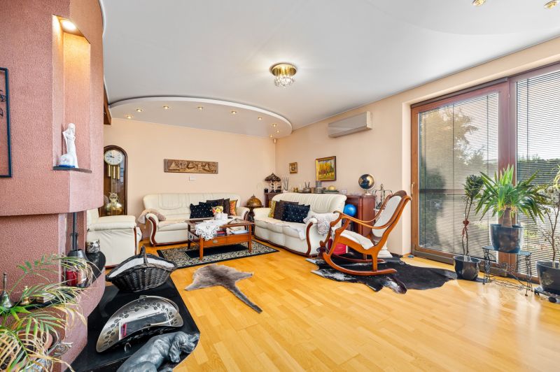 Living room in a family house with a fireplace and a floor with a wood decor.
