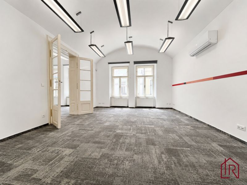Offices with white walls, carpeted floors, and large windows.