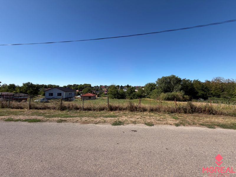 A plot for construction in Lukáčovce on Tichá Street, surrounded by nature and houses.