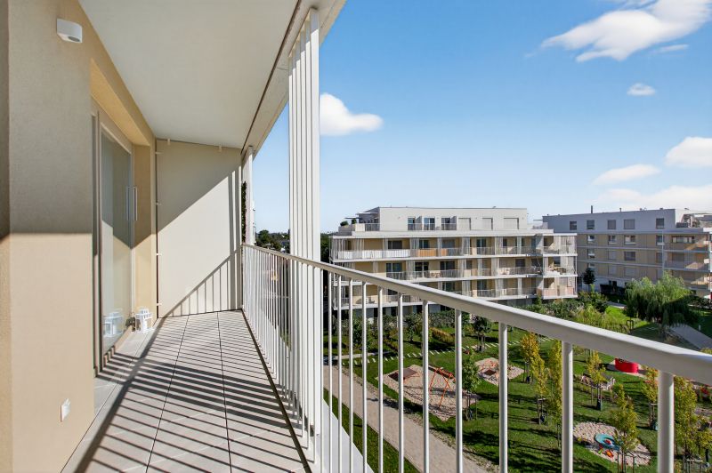 The balcony of a 2-room apartment on Bajkalská Street with a view of greenery in Bratislava.