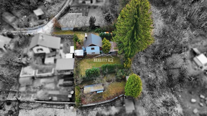 Aerial view of a cottage with a garden in Žilina, surrounded by trees and nature.