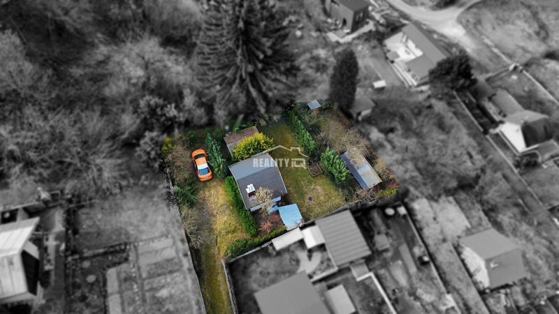 Aerial view of a cottage with a garden and a car in Žilina.
