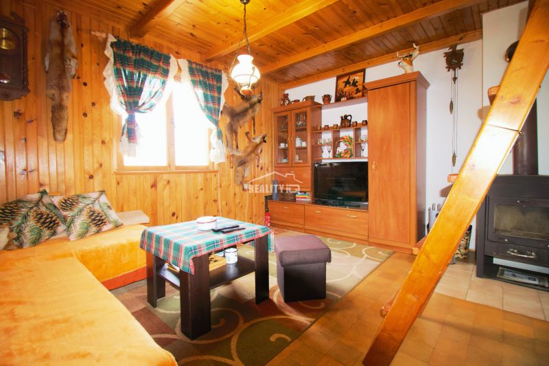 Interior of a cabin with wooden decor and traditional furnishings for a cozy stay.