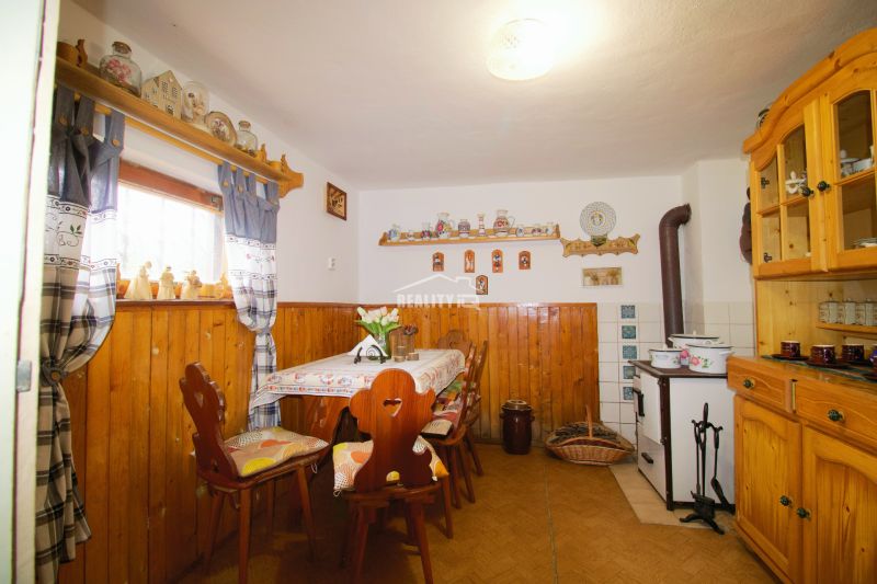 Interior of a cabin with rustic furniture and decorations, floor with wooden decor.