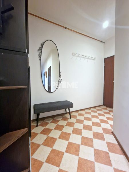 3-room apartment: entrance hall with a black and white bench, mirror, and wall-mounted coat rack.