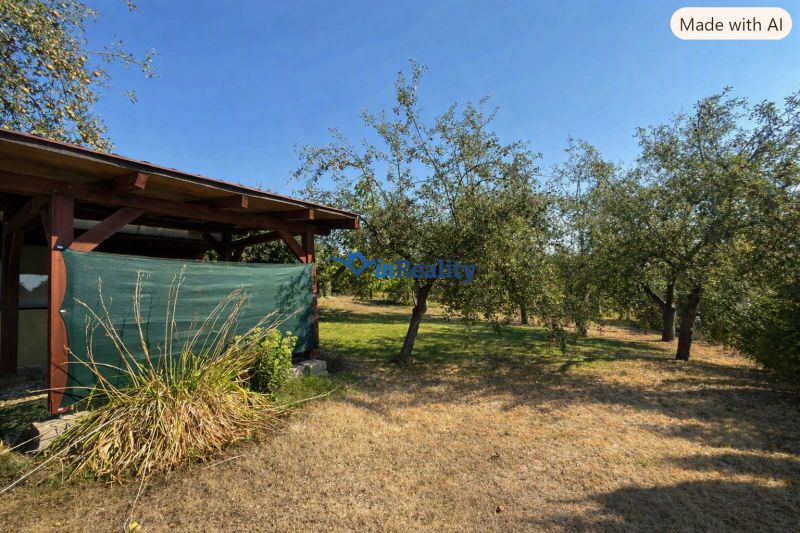 Cottage on the Vineyard in Lučenec surrounded by trees and lawn.